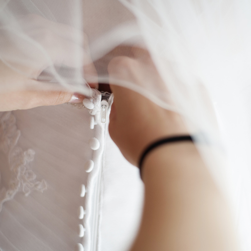 Bride getting wedding dress fitted during alterations appointment in Lakewood Ranch