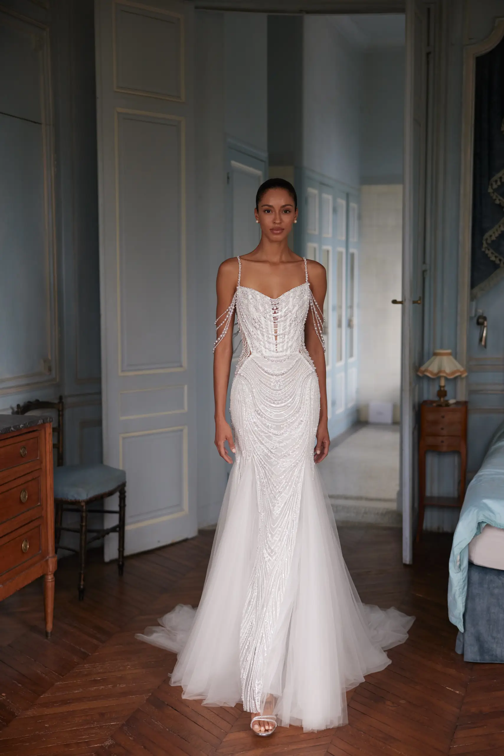 Bride wearing a heavily beaded wedding dress with crystal embellishments and tulle skirt.