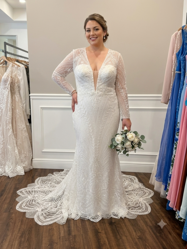 Front view of the Private Label "Hailey" (Ste2608) long sleeve wedding dress in size 18, featuring a sheer illusion neckline, sweetheart bodice, and geometric beadwork.