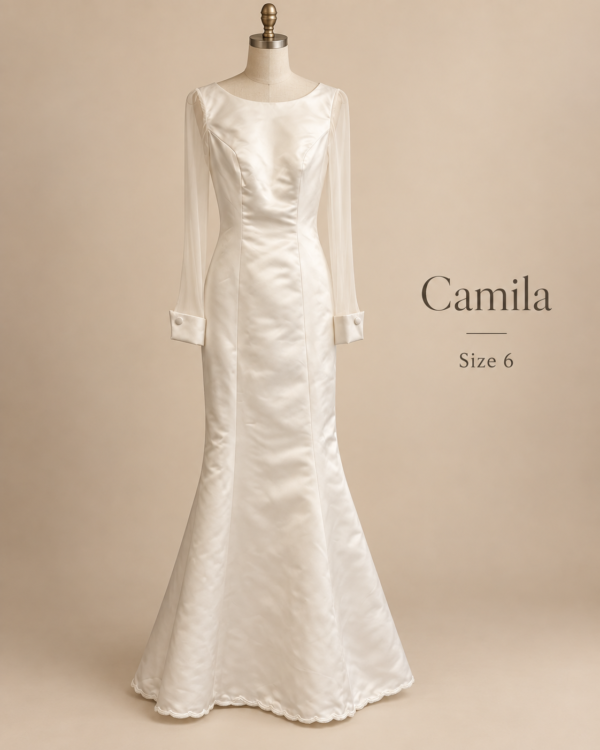 Front mannequin view of Adela-Neve size 4 ivory satin wedding dress with sheer long sleeves and satin cuffs