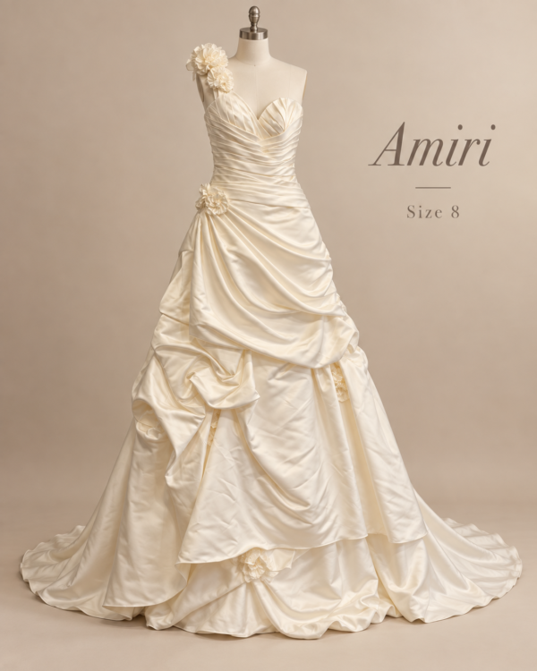 Front view of Amiri size 8 wedding dress with one shoulder floral detail, ruched satin bodice and dramatic pickup ball gown skirt