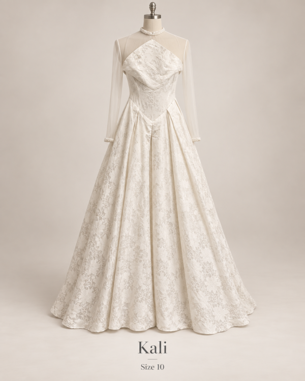 Front view of Kali size 10 wedding dress with high illusion neckline, sheer long sleeves and full floral lace ballgown skirt