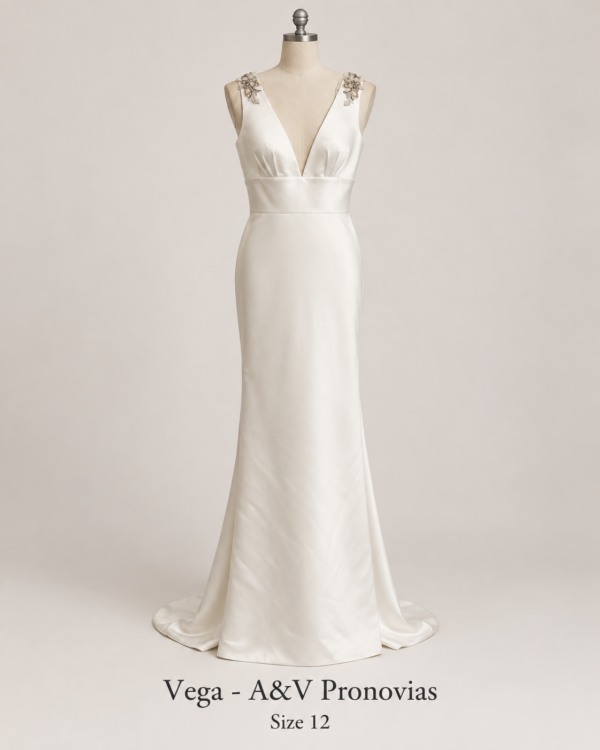 Front mannequin view of Vega A&V Pronovias size 12 satin bridal gown with deep V neckline and jeweled shoulder details